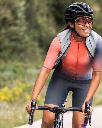 Certified cycling guide Daylin Miller smiles while leading a gravel ride, representing Middle Ground Cycling’s expert and welcoming tour experience.