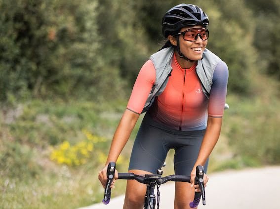 Daylin Miller, co-founder of Middle Ground Cycling, smiles while guiding a gravel bike tour in Girona, Spain—highlighting her passion, strength, and approachable style as a certified cycling guide.